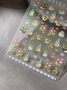 Detailed macro of cactus and cat nail stickers with vibrant holographic laser finish