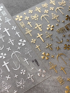 Detail view of gold and silver metallic gothic cross and baroque nail art sticker set