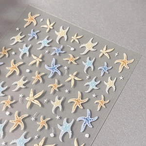 3D embossed starfish and seashell nail art stickers on a textured grey background