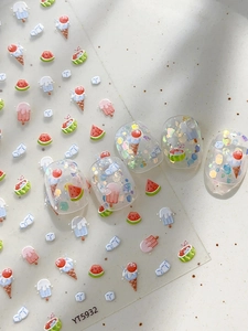 Detail of embossed summer nail stickers featuring ice cream and watermelon patterns