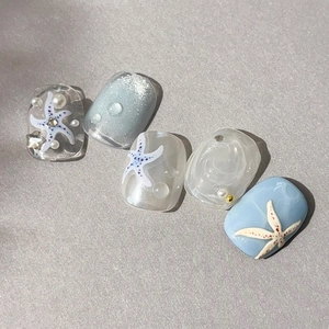 Ocean themed 3D starfish press-on nails with blue pearls and glitter shell texture