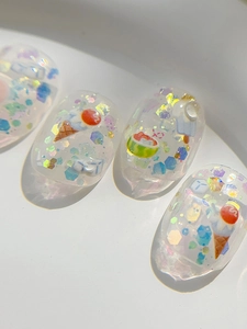 Macro shot of transparent gel nail stickers with 3D ice cream and watermelon summer patterns
