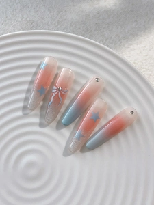 Detail of gradient bow nail stickers with 3D rhinestones and stars on white ceramic