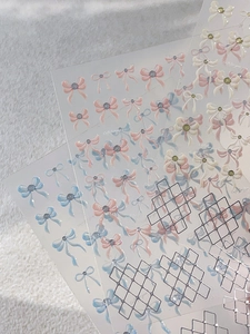 Detail of transparent nail stickers with watercolor bows and silver geometric lines