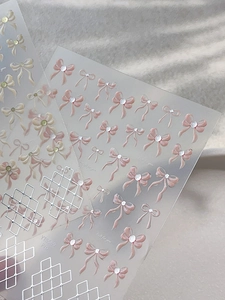 Detail of 3D bow and silver grid nail stickers with embossed texture on YT5589 Pro