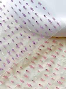 Detail view of cute cartoon fish nail art stickers in purple and pink styles