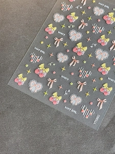 Detail of 3D embossed nail art stickers with cherry, bowknot and star designs
