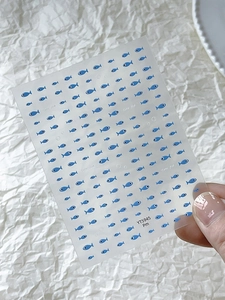 Detail of blue fish nail art stickers YT5945 on a transparent sheet for manicure