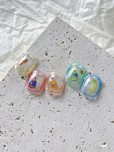 Macro detail of colorful resin beverage nail charms and DIY craft accessories