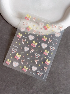 Macro shot of 3D embossed nail stickers featuring pink cherry and lace heart designs
