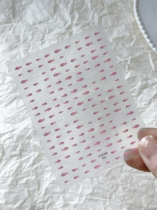 Detailed sheet of cute pink fish nail art stickers with clear transparent backing