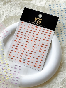Macro detail of YT5944 cute fish nail art stickers with orange fish on card packaging