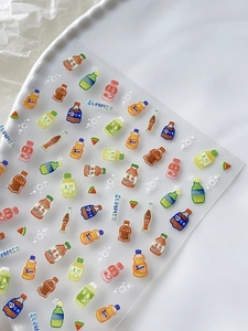 Detail of transparent summer beverage nail stickers with soda and watermelon motifs