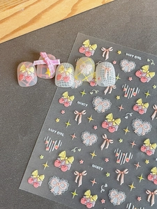 Detail of embossed cherry and bow nail art stickers with pink 3D relief heart patterns