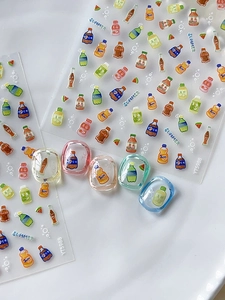 Macro detail of summer beverage nail stickers featuring soda bottles and fruit patterns