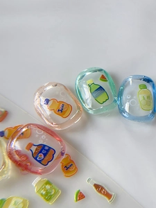 Macro shot of 3D resin nail art charms featuring colorful summer beverage bottle designs