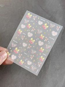 Detailed view of cherry bow embossed nail art stickers with heart and star patterns