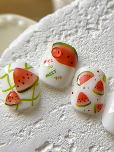 Macro shot of summer watermelon nail decals with hand-drawn fruit art and nice typography