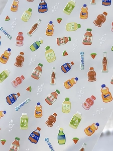 Macro shot of 3D embossed summer beverage nail stickers with soda and fruit designs