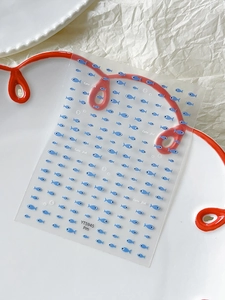 Macro view of blue fish nail art stickers with Cute Fish text and bubble details