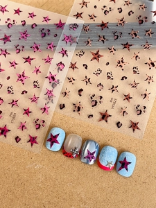 Macro detail of leopard star nail stickers in pink-purple and coffee brown patterns