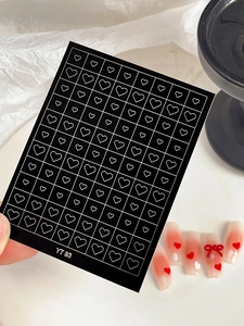 Detail of YT93 nail stickers featuring white heart patterns on gradient pink and white nails