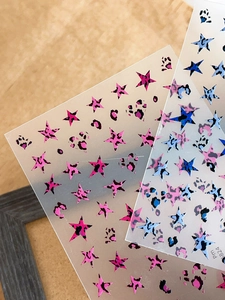 Detail of leopard print star nail stickers in pink and blue for manicure art design