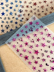 Detail of 3D nail stickers featuring blue and pink leopard print star patterns