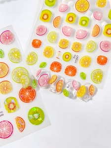 Detailed view of summer fruit nail art stickers with lemon, kiwi, and orange patterns