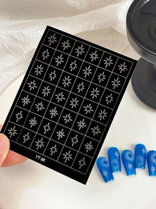 Detail of YT 98 white star nail art stickers showing decals on blue glitter manicure