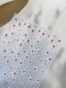 Macro detail of YT5941 nail stickers featuring white floral patterns and green leaves