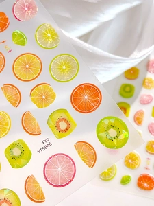 Detail of 3D layered fruit nail stickers featuring lemon and lime with glitter edges