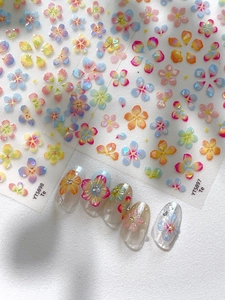 3D seashell flower nail stickers in pastel colors and macro detail on white background