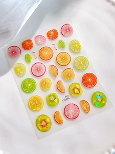 Detailed 3D fruit slice nail stickers with gold foil and citrus patterns on white base