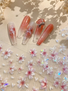 Detail of 3D embossed cherry blossom nail stickers with iridescent shimmer and gradient art