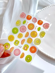 Detailed view of translucent fruit nail stickers featuring lemon and lime slices YT5846