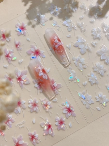 Detailed view of floral nail art stickers with pink gradient and laser white petals