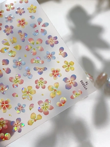 Macro shot of colorful shell luster floral nail art stickers with laser holographic finish
