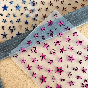 Leopard print star and paw nail art stickers in pink, blue, and brown tones