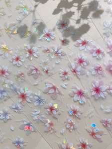 Detailed close-up of 5D embossed shell flower nail stickers with laser iridescent finish