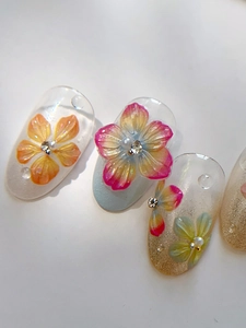 Macro detail of 3D embossed floral nail stickers with resin flowers and rhinestones