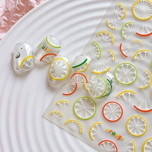 Summer lemon fruit nail stickers with colorful citrus slices on white textured plate