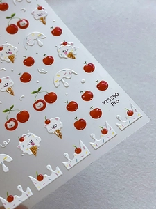 Detailed macro view of 3D embossed cute puppy and cherry nail art stickers with textured relief