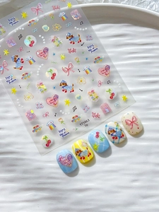 Detail of cute nail stickers with shell luster hearts, bows, and colorful puppy patterns