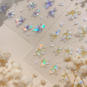 Iridescent laser flower nail stickers with 3D shell light effect on beige background
