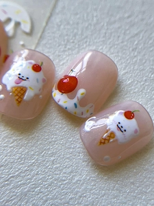 Macro detail of kawaii nail art with cute white bear, ice cream and cherry patterns