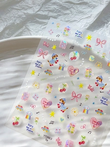 Detail of colorful bow and heart nail stickers with laser effect on a white plate