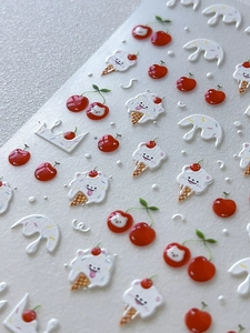 Close-up of 3D embossed nail stickers featuring cute cherry and bear ice cream designs