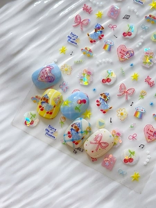 Detailed macro of 5D embossed nail stickers featuring cute dog, bow, and heart patterns