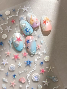 Macro detail of ocean starfish nail stickers and shell gradient press-on nails